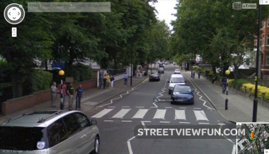 Four guys getting ready to enact Abbey Road Beatles