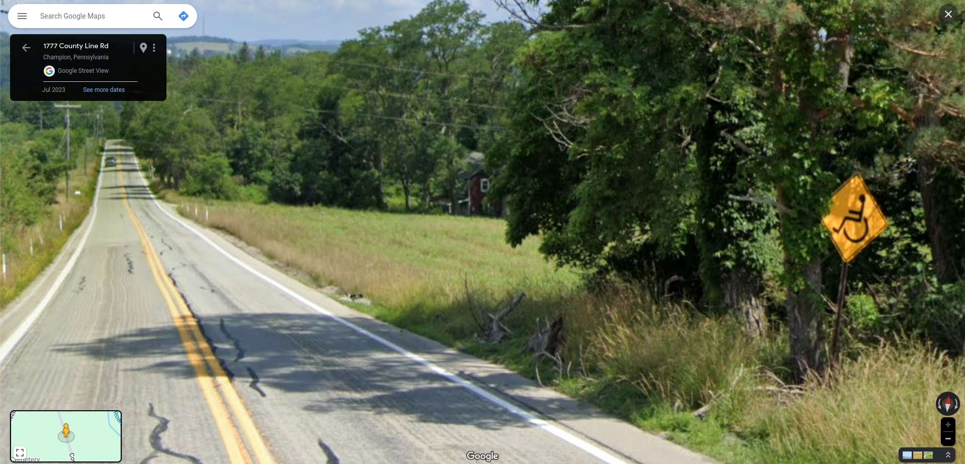 Sign warning of wheelchair crossing on the road StreetViewFun