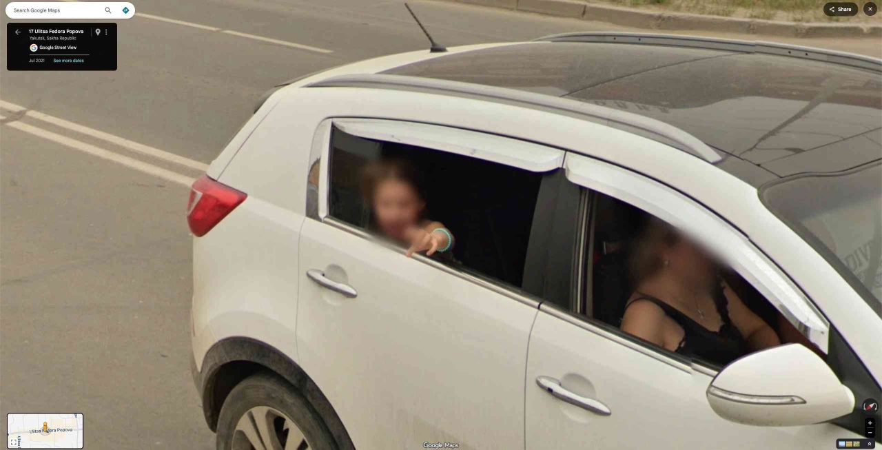 girl pointing at google car